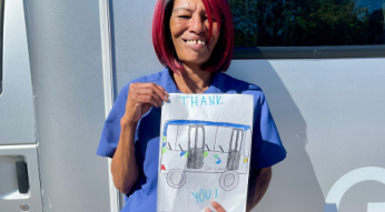 Bus Driver Holding a Thank You Drawing